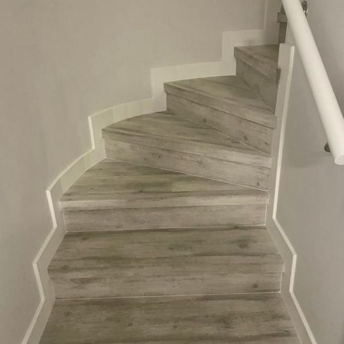 MU141 ESCALERAS EN CURVA CON SUELO QUICK STEP Y REMATADAS CON RODAPIE LACADO BLANCO